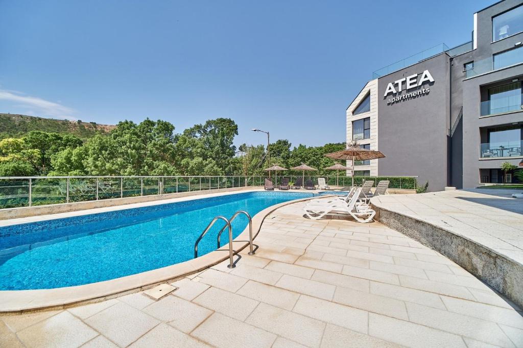 a swimming pool in front of a building at 100m from the BEACH! ALDEA complex with pool in Kavarna