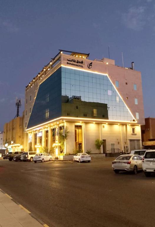 a large building with cars parked in a parking lot at بنان للشقق المخدومه&Banan Serviced Apartments in Tabuk