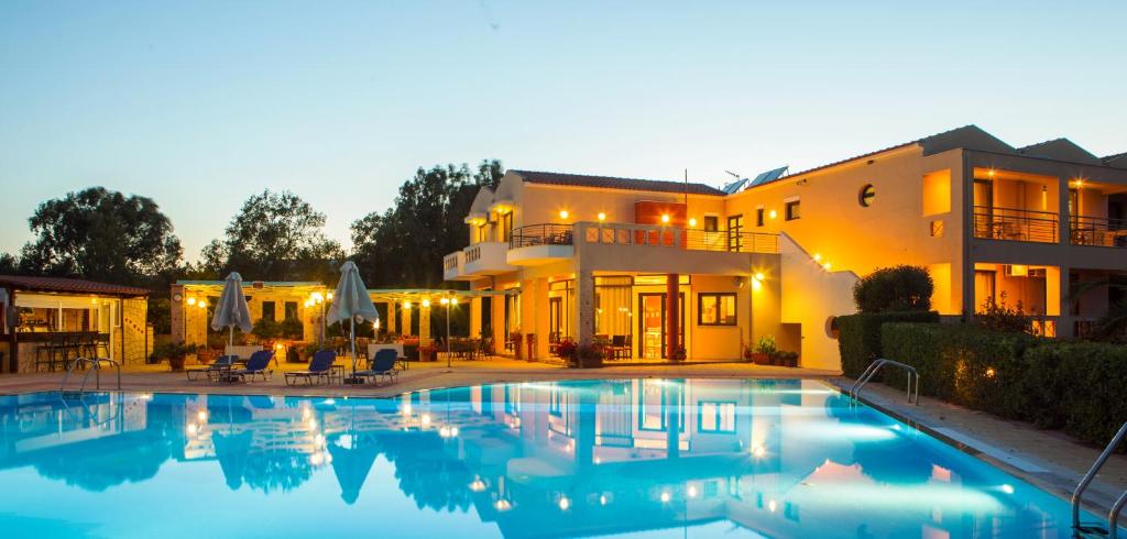 a large swimming pool in front of a house at Aeolian Gaea Hotel in Skala Kallonis