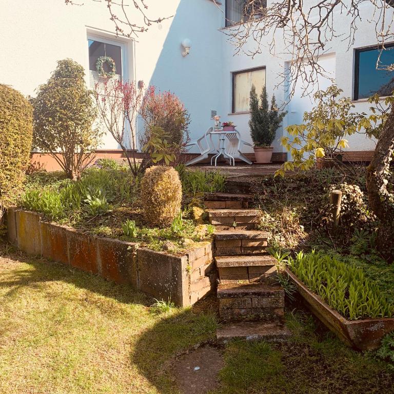 a garden with stairs in front of a house at Im Herzen von Chattengau in Gudensberg
