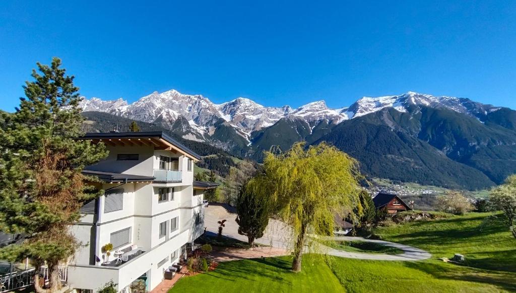 a house with mountains in the background at Haus Schmid in Tobadill