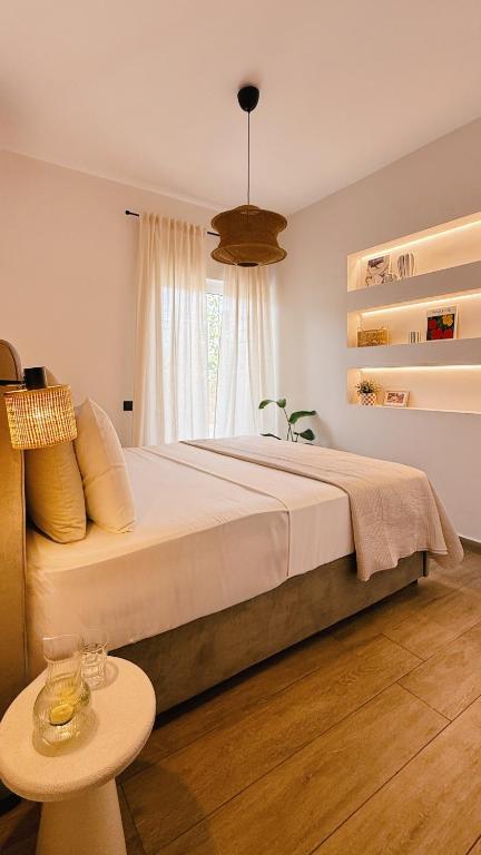 a bedroom with a large bed and a table at Tashó Simply Living in Xylokastro