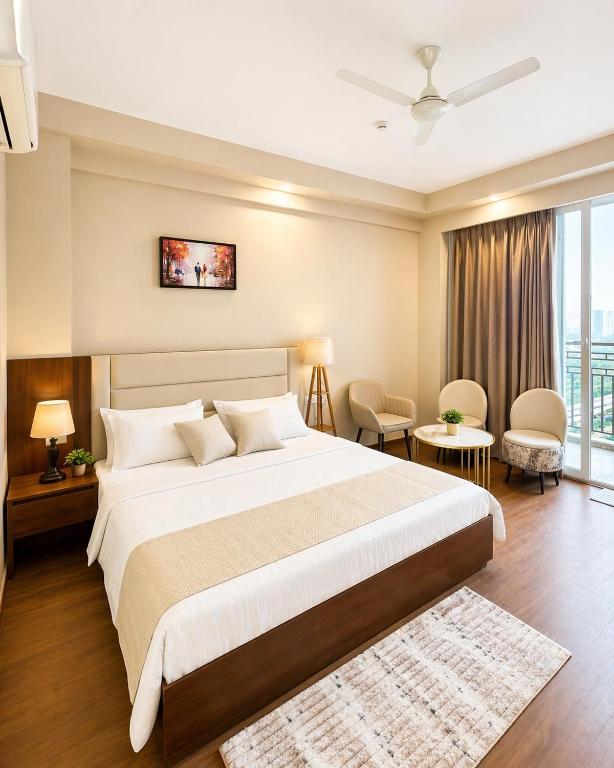 a bedroom with a large bed and a large window at Veloria Grand Suites in Greater Noida