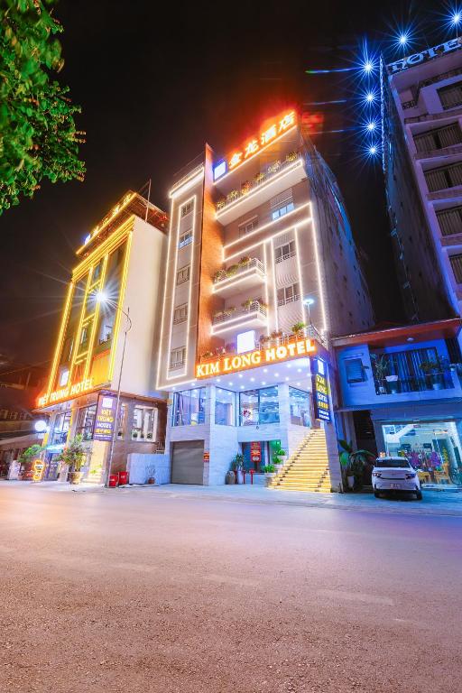 a group of buildings at night with a street at Kim Long Hotel Lao Cai - Near Hekou Border Gate in Lao Cai