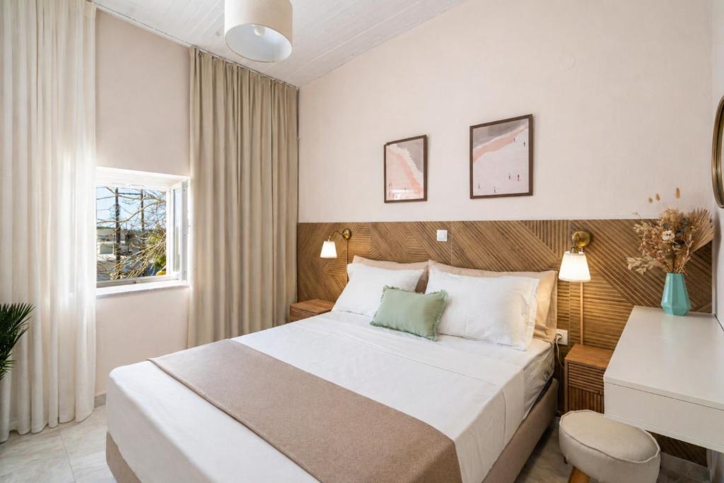 a hotel room with a bed and a window at Mesogitonia House in Zekros