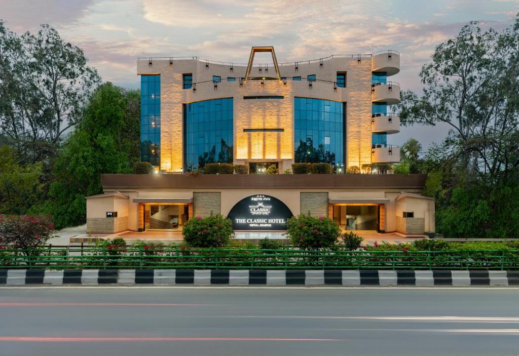 a building with a sign in front of it at The Classic Hotel in Imphal