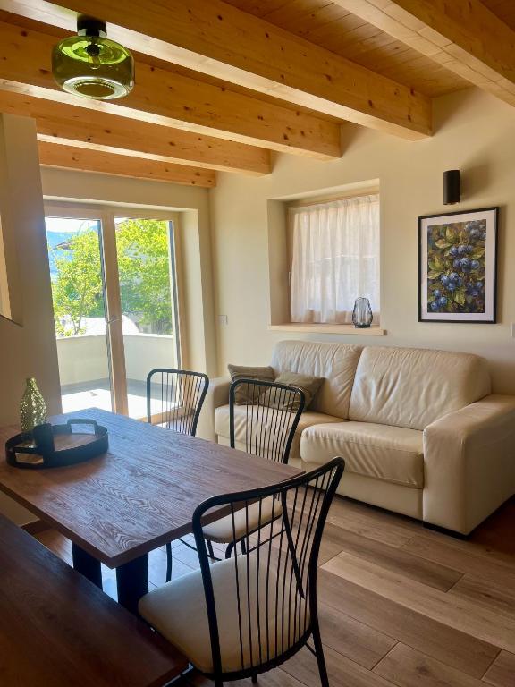 a living room with a table and chairs and a couch at Mirtillo in Tassullo