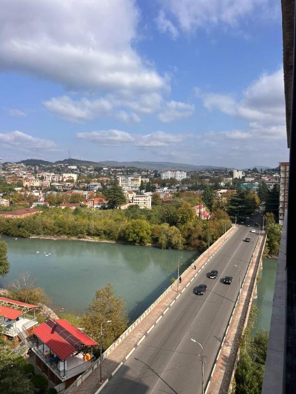 a bridge over a river with cars on a road at Comfortable 5 rooms apartment in Kutaisi