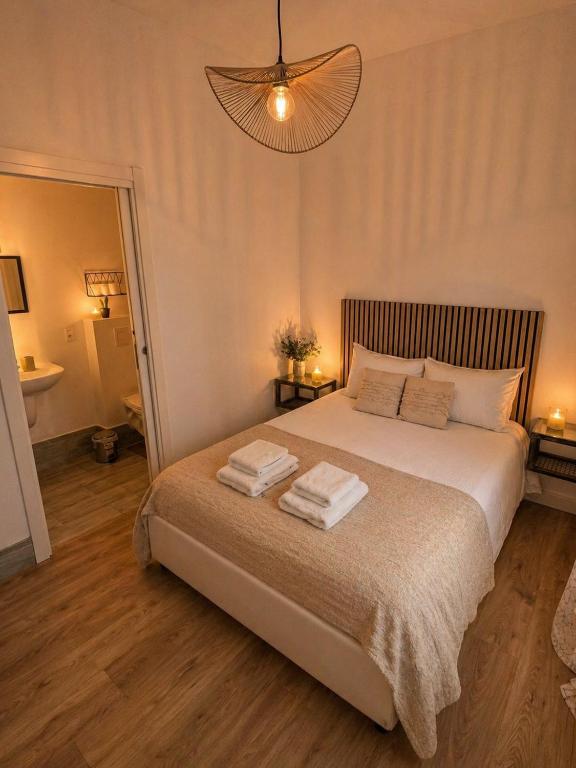 a bedroom with a bed with two towels on it at Chambre Confort Premium - Monaco 2 in Beausoleil