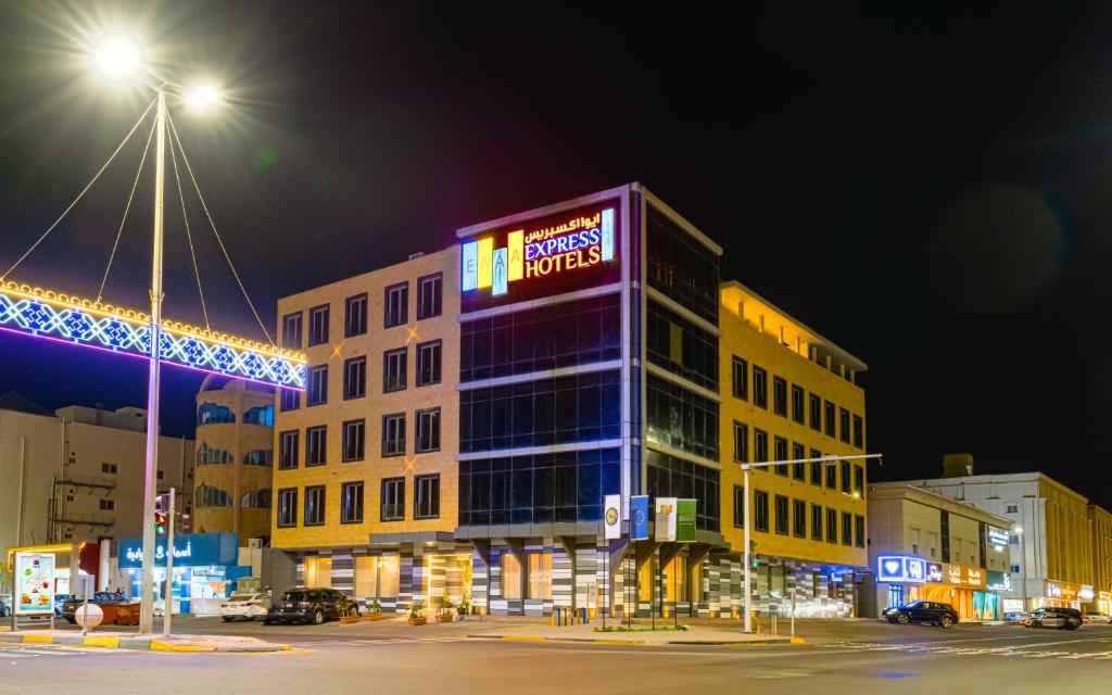 a building with a sign on top of it at night at Ewaa Express Hotel - Yanbu Alamarah in Yanbu