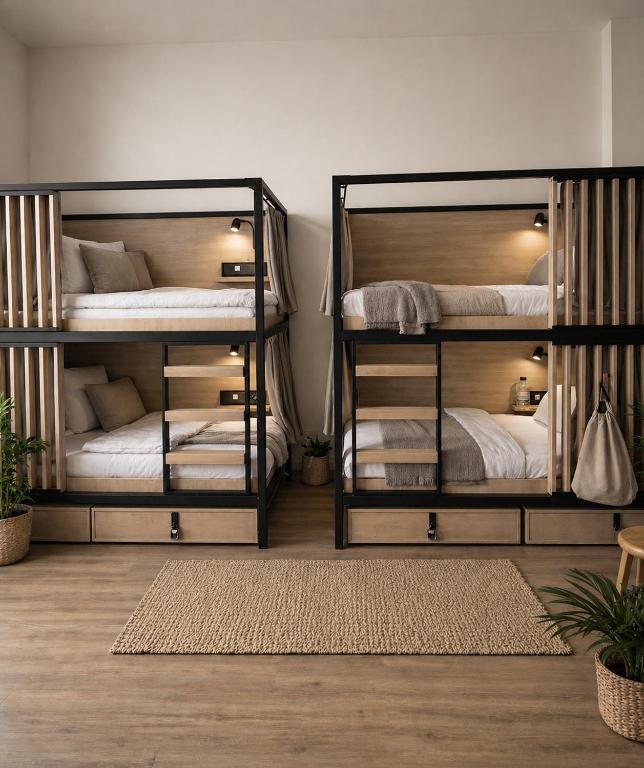 a room with two bunk beds with white sheets at Berlin Sleep Club in Berlin