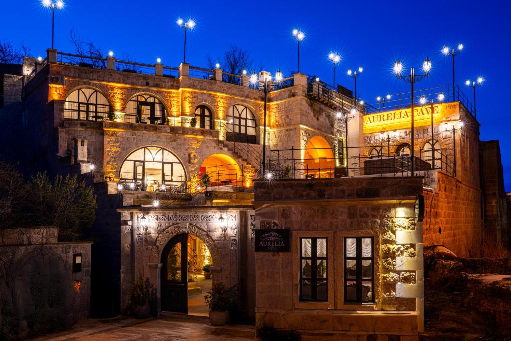a building with lights on top of it at night at Aurelia Cave Cappadocia - Special Class in Nevşehir