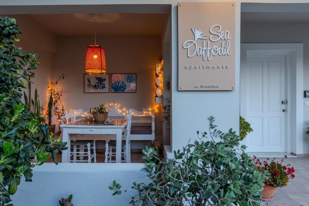 a dining room with a table and a sign that reads sun unifiedpaces at Sea Daffodil apartments in Kissamos