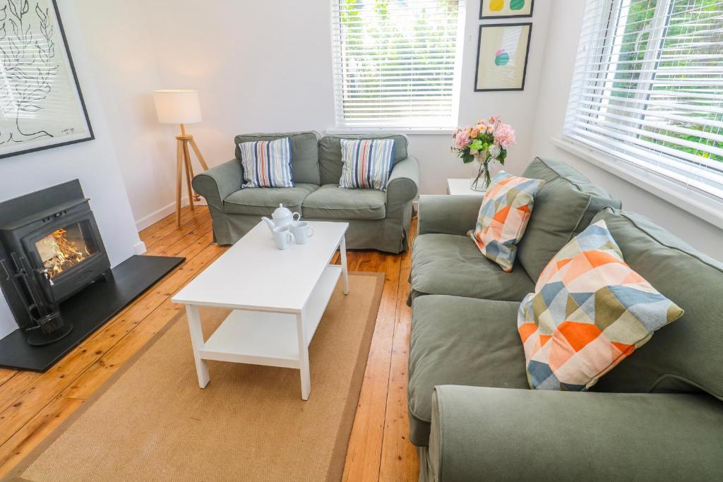 a living room with a couch and a fireplace at Bod A Quinte in St Ives