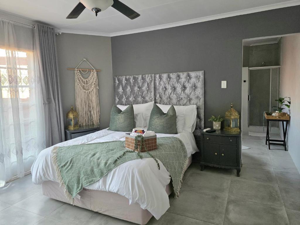 a bedroom with a large bed with a basket on it at Grey Crescent living in Welkom