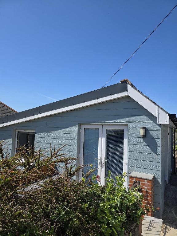 a blue house with a pitched roof at Downside Annexe in Woolacombe
