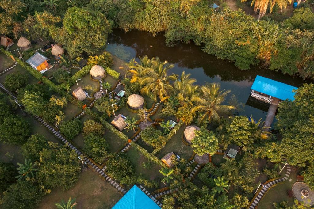 an overhead view of a resort with palm trees and a river at Hotel MulataRetreat in La Mesa