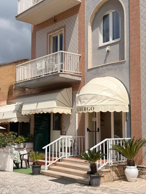 a building with stairs and balconies on a building at Albergo Villa Marina in Anzio