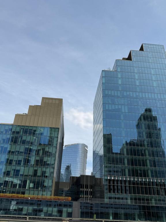 two tall glass buildings in a city at Elegancki apartament w centrum in Warsaw