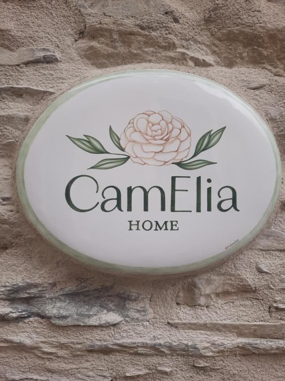 a sign for a home on a brick wall at CamElia in Garlenda