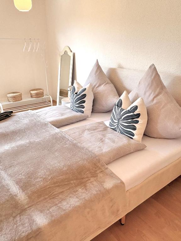 a couch with pillows on it in a room at Auszeit in Bullay