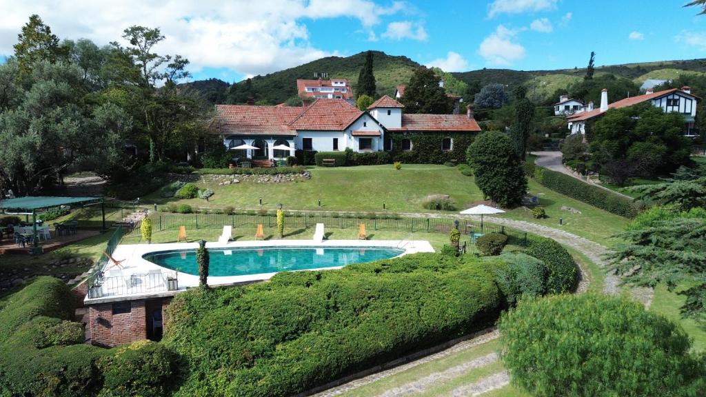 a house with a swimming pool in a yard at Posada los Cedros in La Cumbre