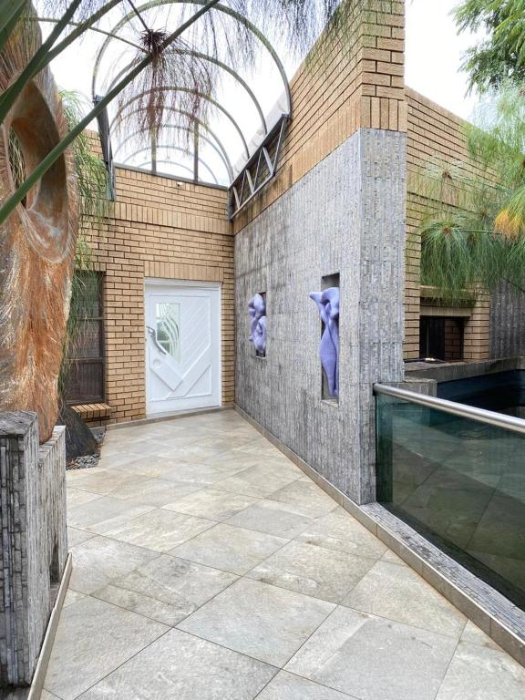 a building with a white door with purple paintings on it at The View on Nyle Rustenburg in Rustenburg