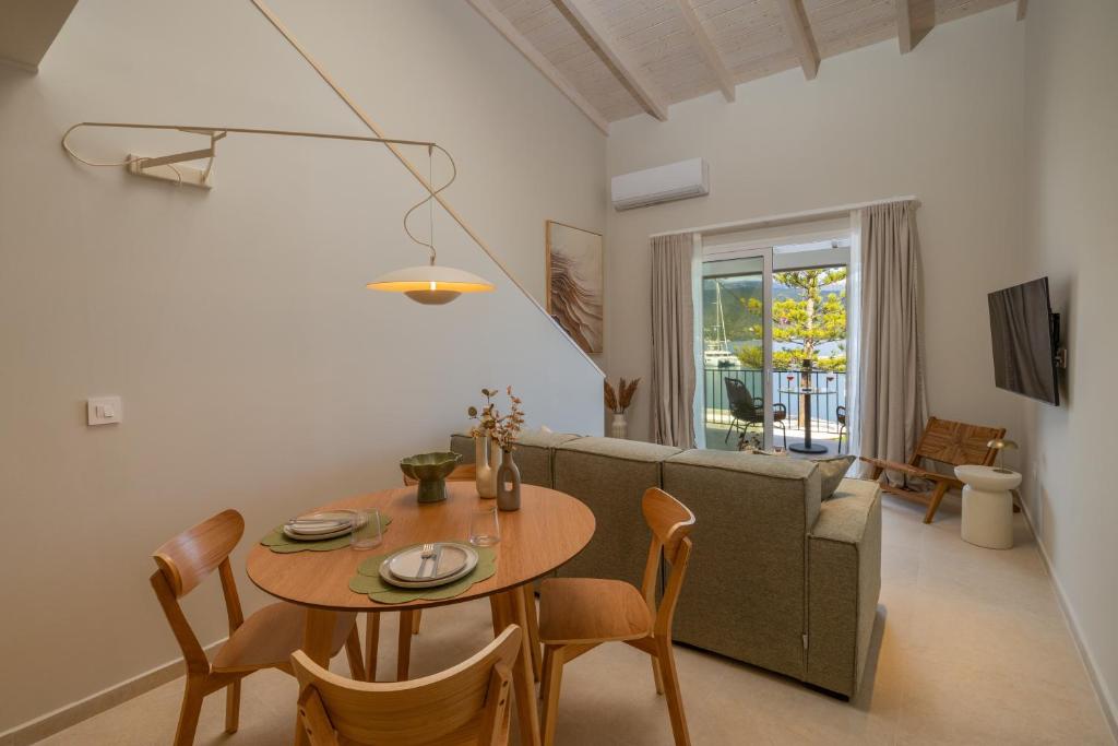a living room with a table and a couch at Cavaliere Seafront House - Thalia in Sami