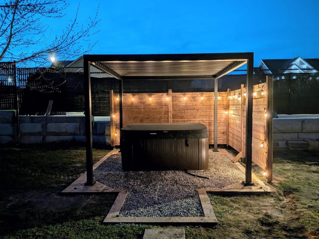 a barbecue under a gazebo with lights on it at Red Roof Guesthouse in Cobourg
