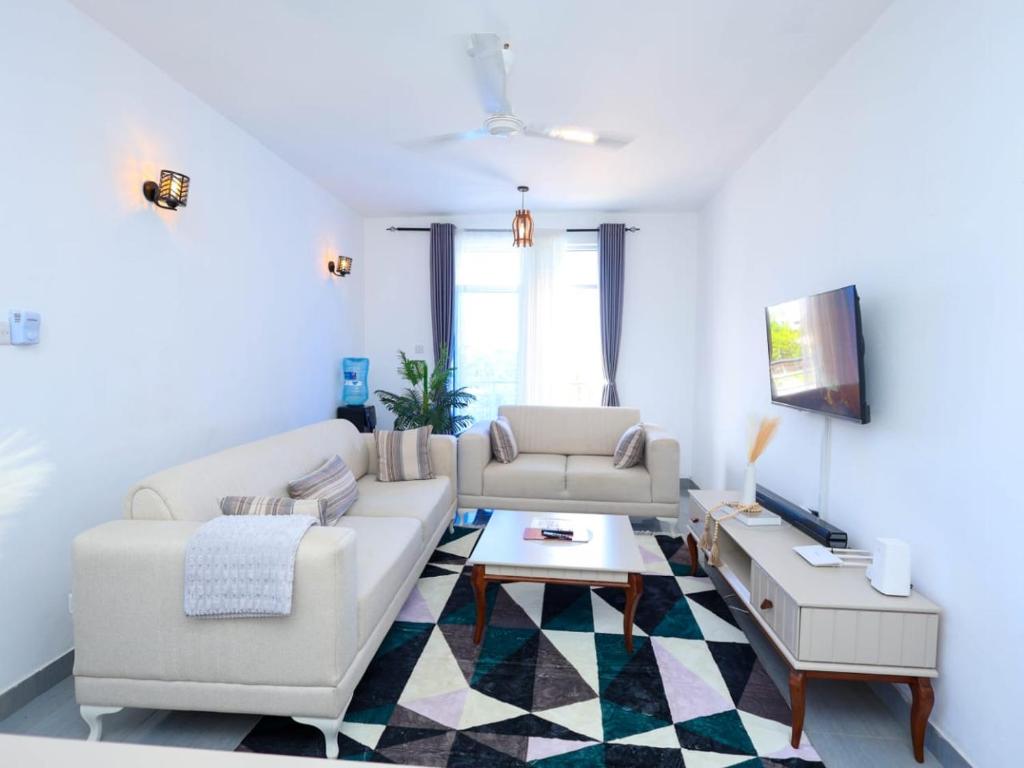 a living room with a couch and a table at Kenya coast stays in Nyali
