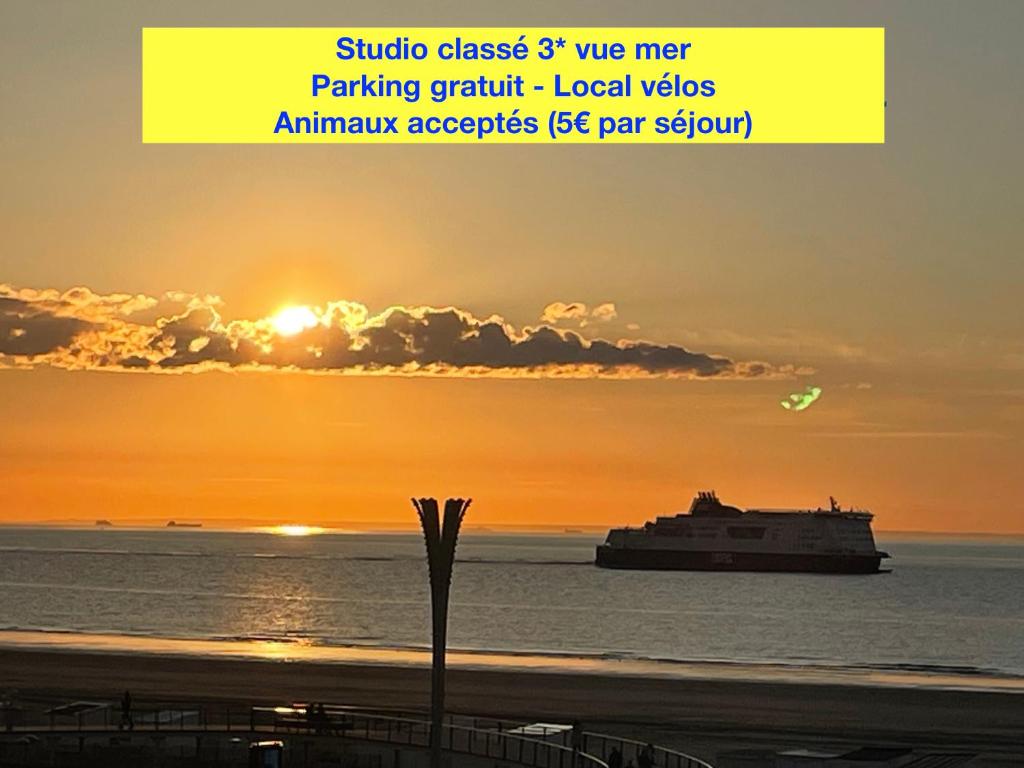 a cruise ship in the ocean at sunset at Studio à la plage - Vue mer in Calais