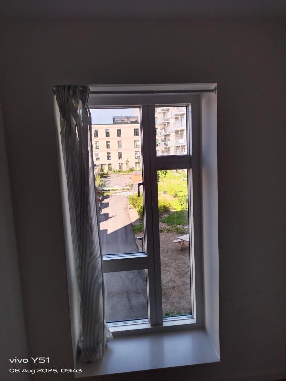 an open window with a view of a building at Nordic Sleep Spot in Glostrup
