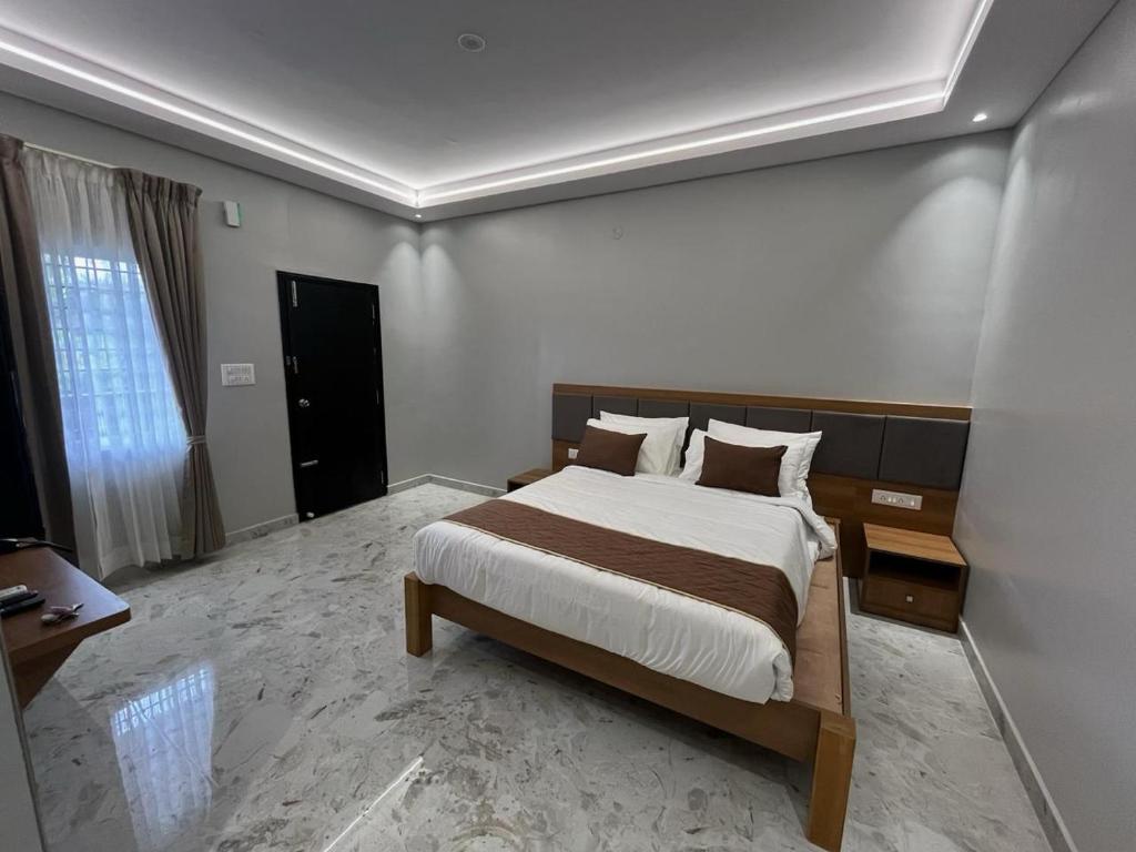 a bedroom with a large bed in a room at Sancara Business Hotel in Jāmb
