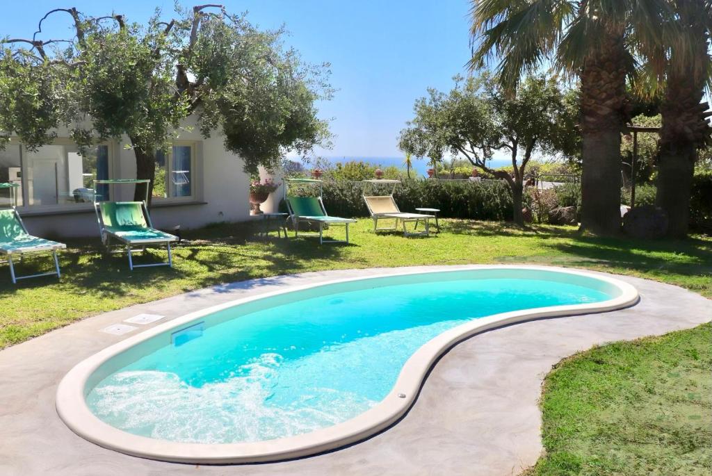 a swimming pool in the yard of a house at Sorgeto Garden in Forio d'Ischia