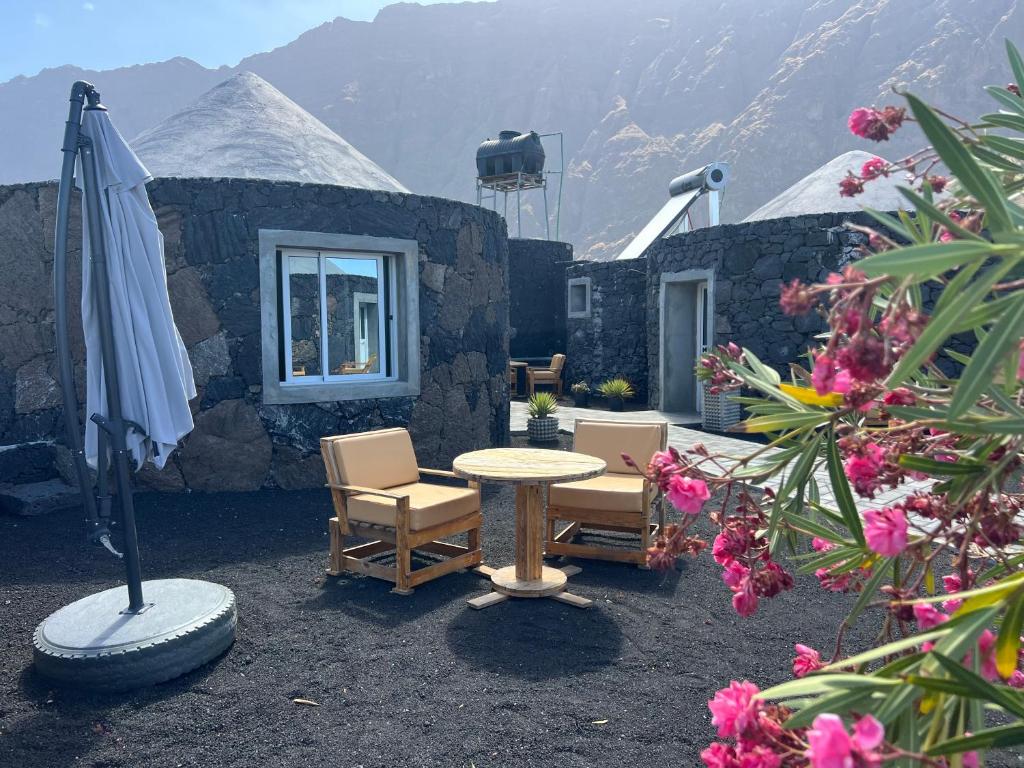 a patio with a table and two chairs and an umbrella at EcoFunco in Portela