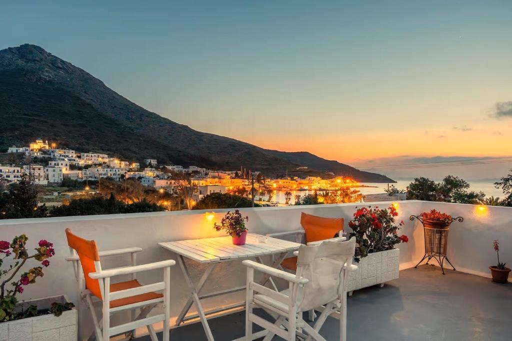 a balcony with a table and chairs overlooking a city at Angeliki Pension in Katapola