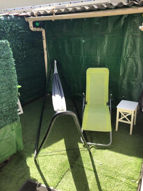 a tent with a chair and a umbrella at Studio cosy in Orly