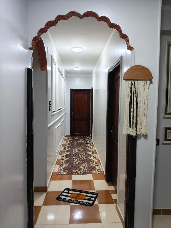 an arched hallway with a door and a tile floor at sunset in Abu Simbel