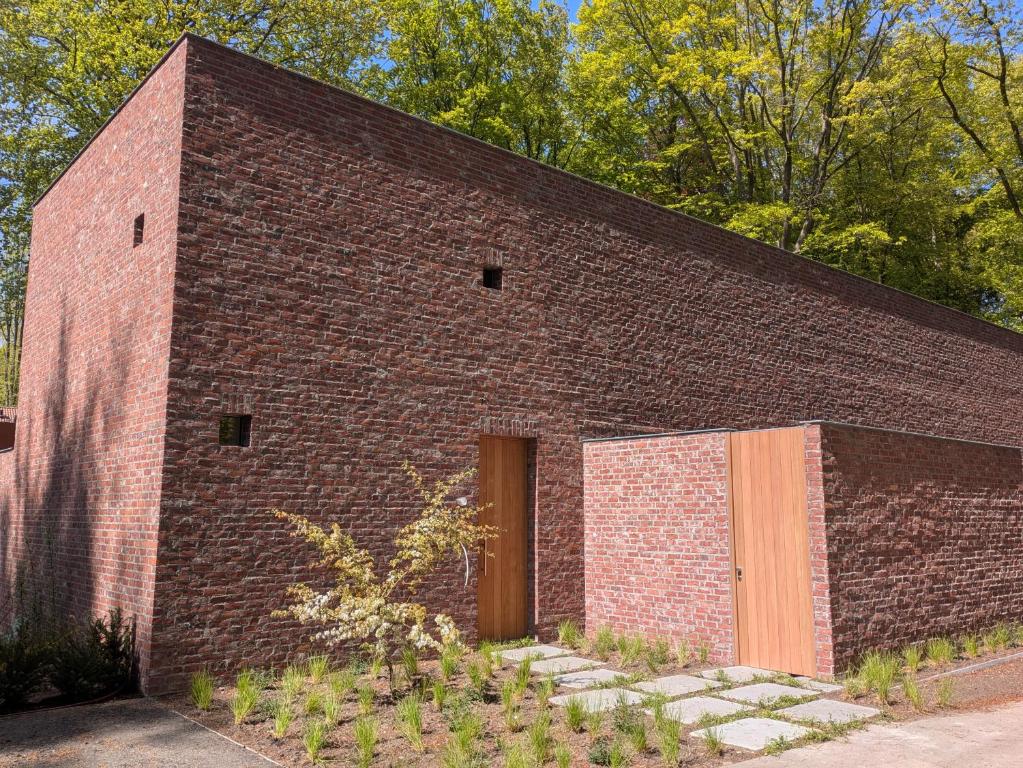 a brick building with a door on the side of it at Herman in Bruges