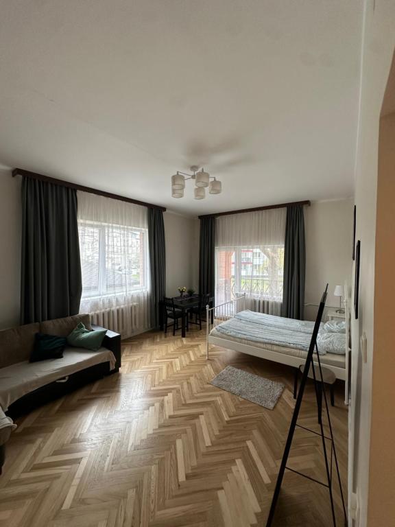 a living room with a bed and a couch at K14 Stay 1 in Riga