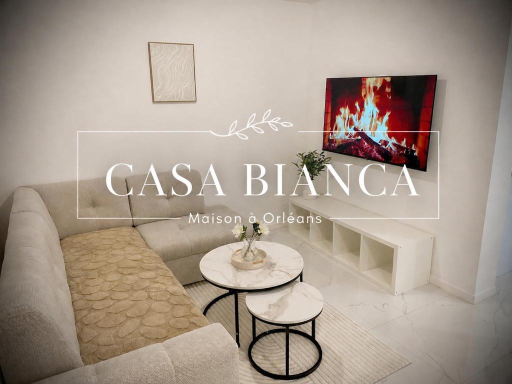 a living room with a couch and a table at Casa Bianca - Maison à Orléans in Orléans