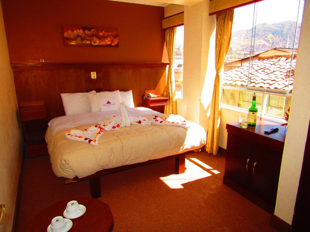 Postel nebo postele na pokoji v ubytování Hotel Waynapicchu