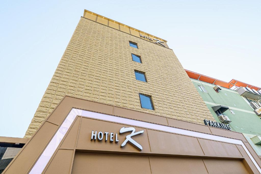 a hotel sign on the front of a building at Ilsan Hotel K in Goyang