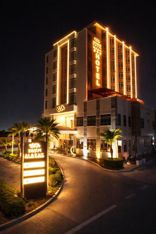 a building with a sign in front of it at night at فندق الراية الفندقية in Jazan