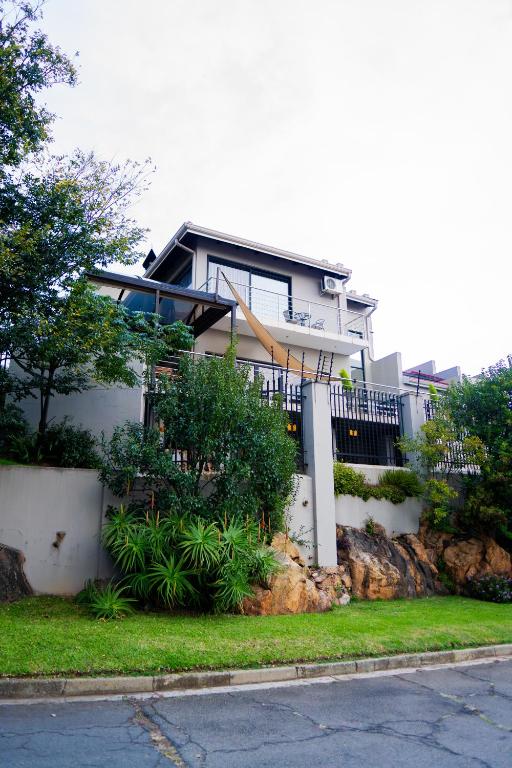 a house sitting on top of a hill at AB&AB Guesthouse Bedfordview in Germiston