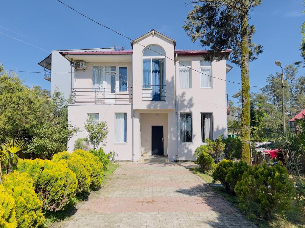 a white house with a pathway at Gulis Home in Shekhvetili