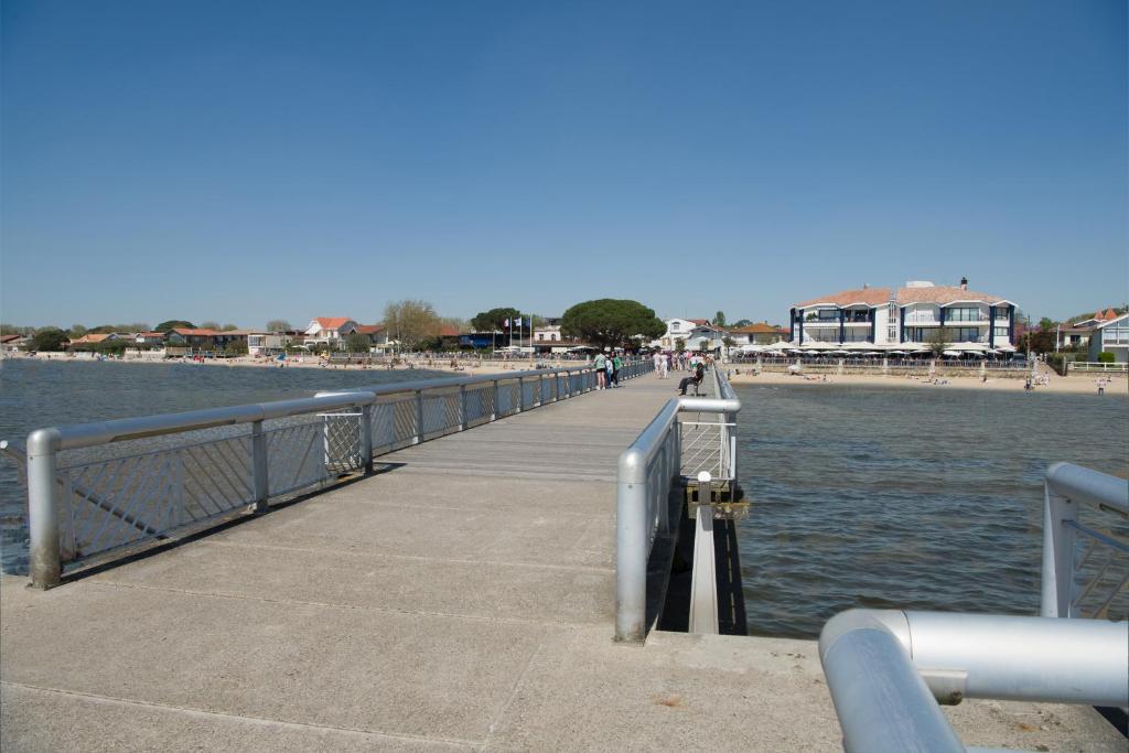 a pier next to a body of water at Les libellules in Andernos-les-Bains