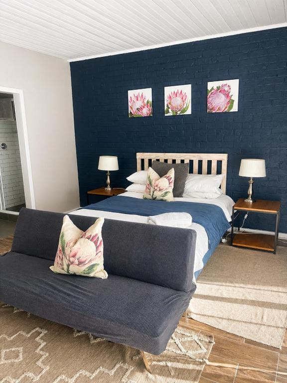 a bedroom with a large bed and a couch at Wedmore Place in Grahamstown