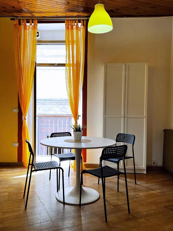a table and chairs in a room with a window at Nel Cuore di Lanciano - WeclHome in Lanciano