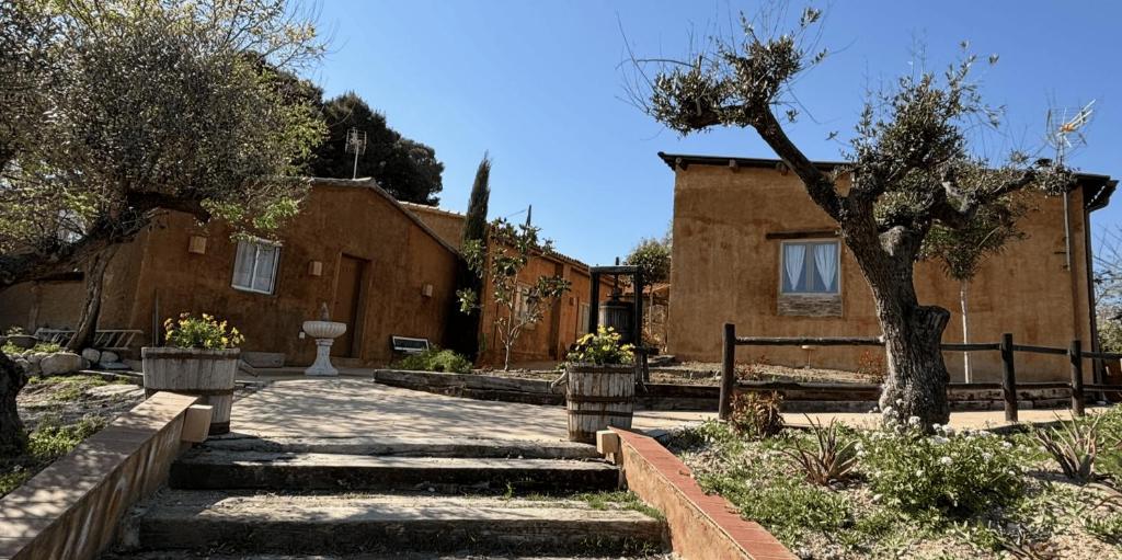 a house with a tree and stairs in front of it at Masoala Forest in Piera